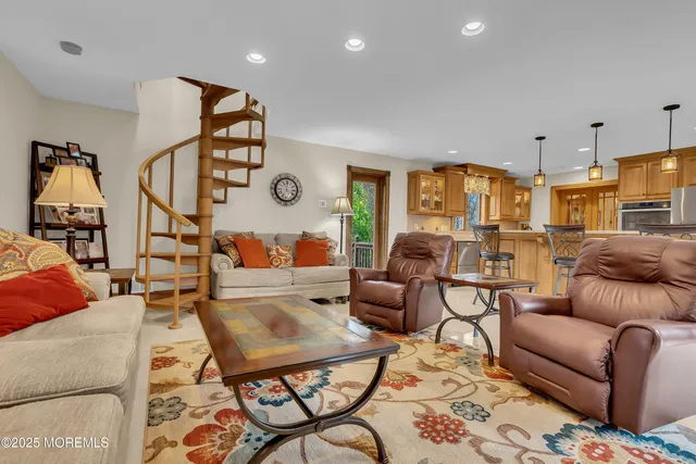 a living room with furniture a rug and a chandelier