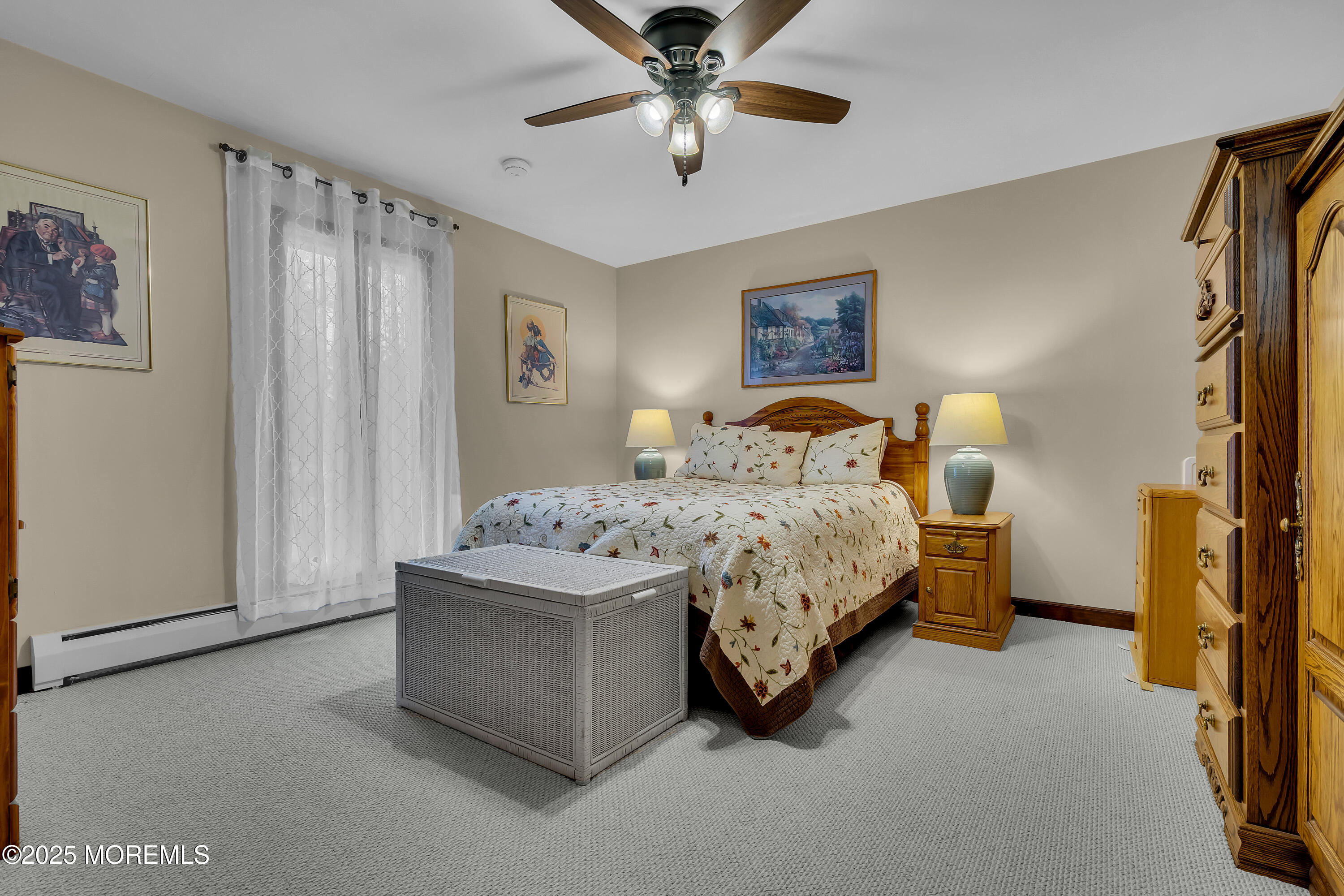 49 Highbridge Road New Egypt, NJ 08533 - Photo 27 of 44 a bedroom with a bed and a chandelier