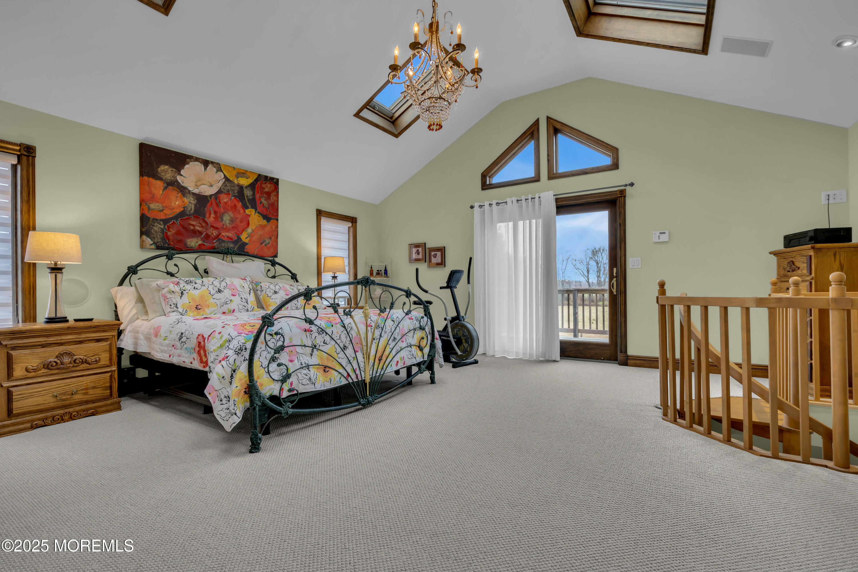 49 Highbridge Road New Egypt, NJ 08533 - Photo 30 of 44 a bedroom with a bed and a chandelier