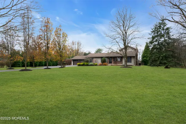 a view of house with a yard