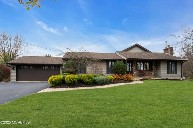 a front view of a house with a garden and sitting area