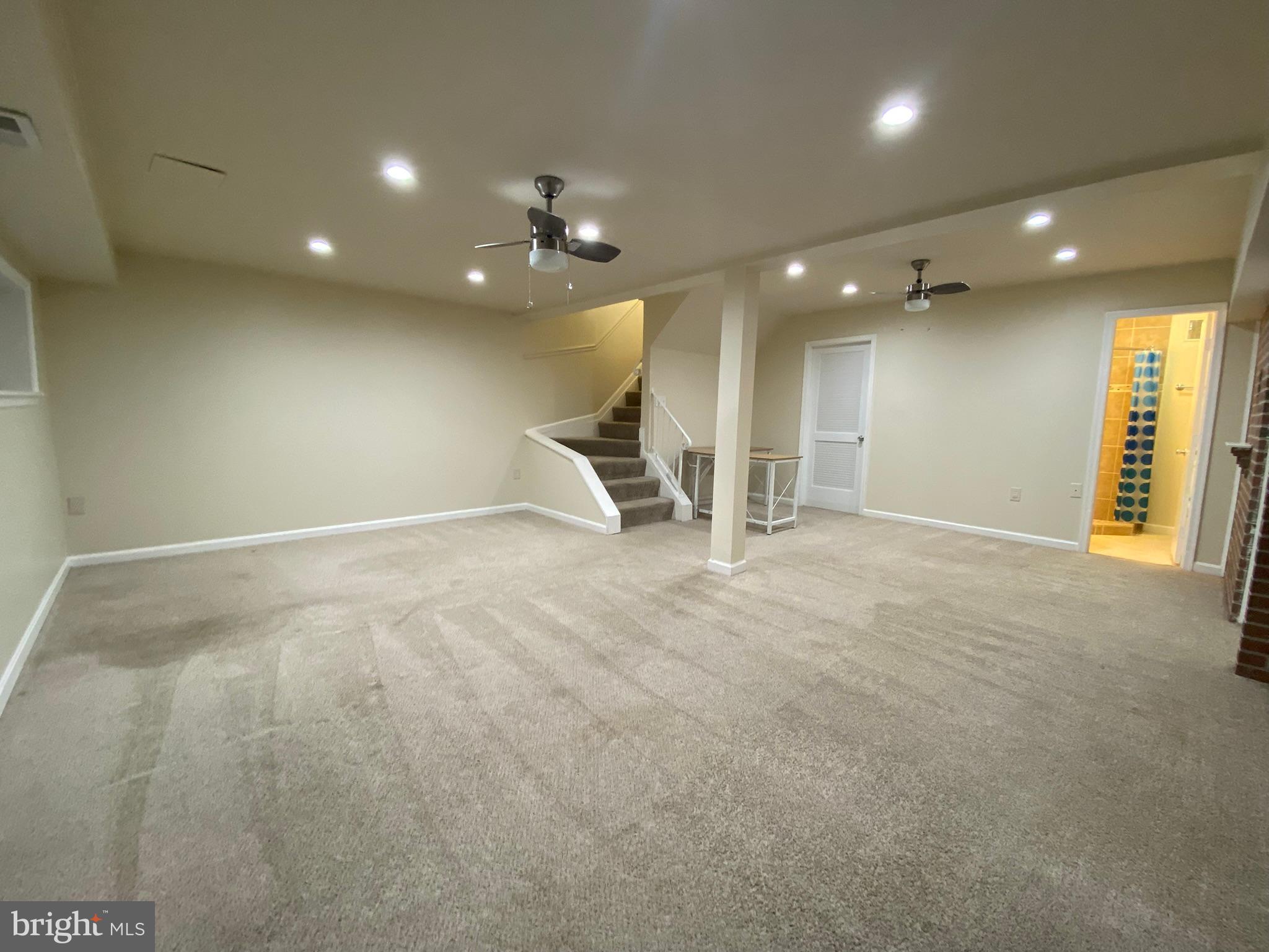 7432 Pohick Road Lorton, VA 22079 - Photo 11 of 27 an empty room with windows and fan