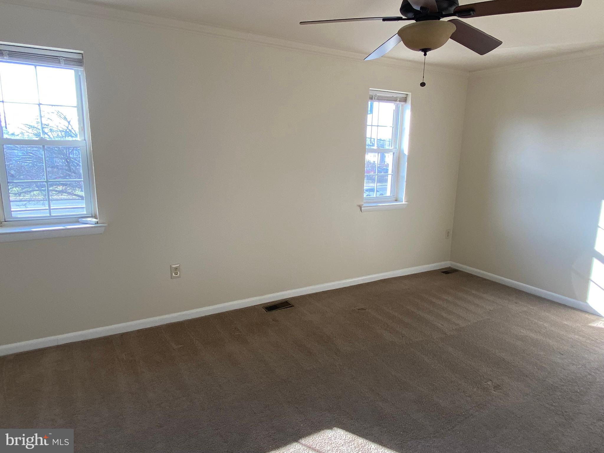 7432 Pohick Road Lorton, VA 22079 - Photo 15 of 27 an empty room with a window and a fan