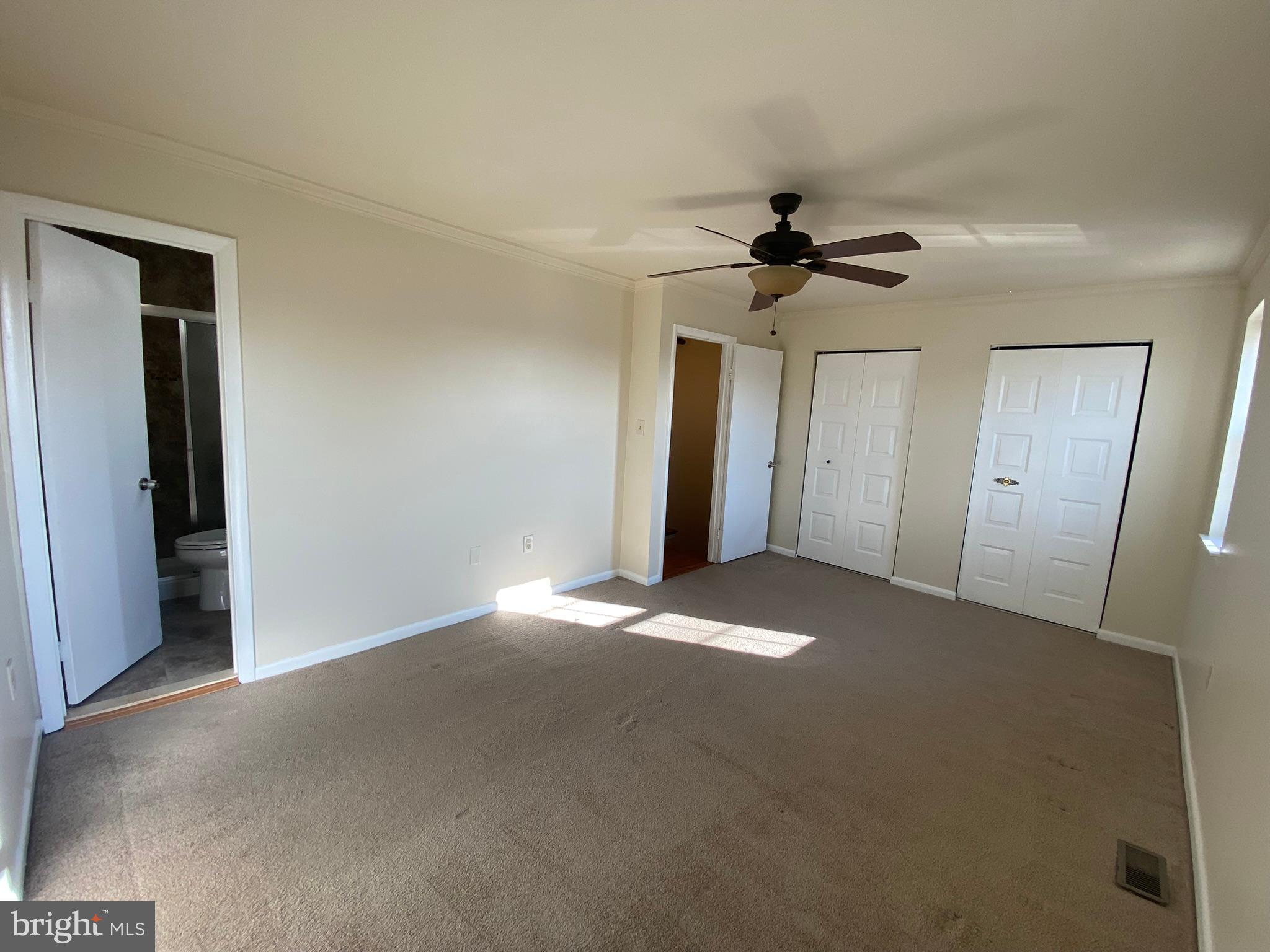 7432 Pohick Road Lorton, VA 22079 - Photo 16 of 27 a view of a big room with a chandelier fan and windows