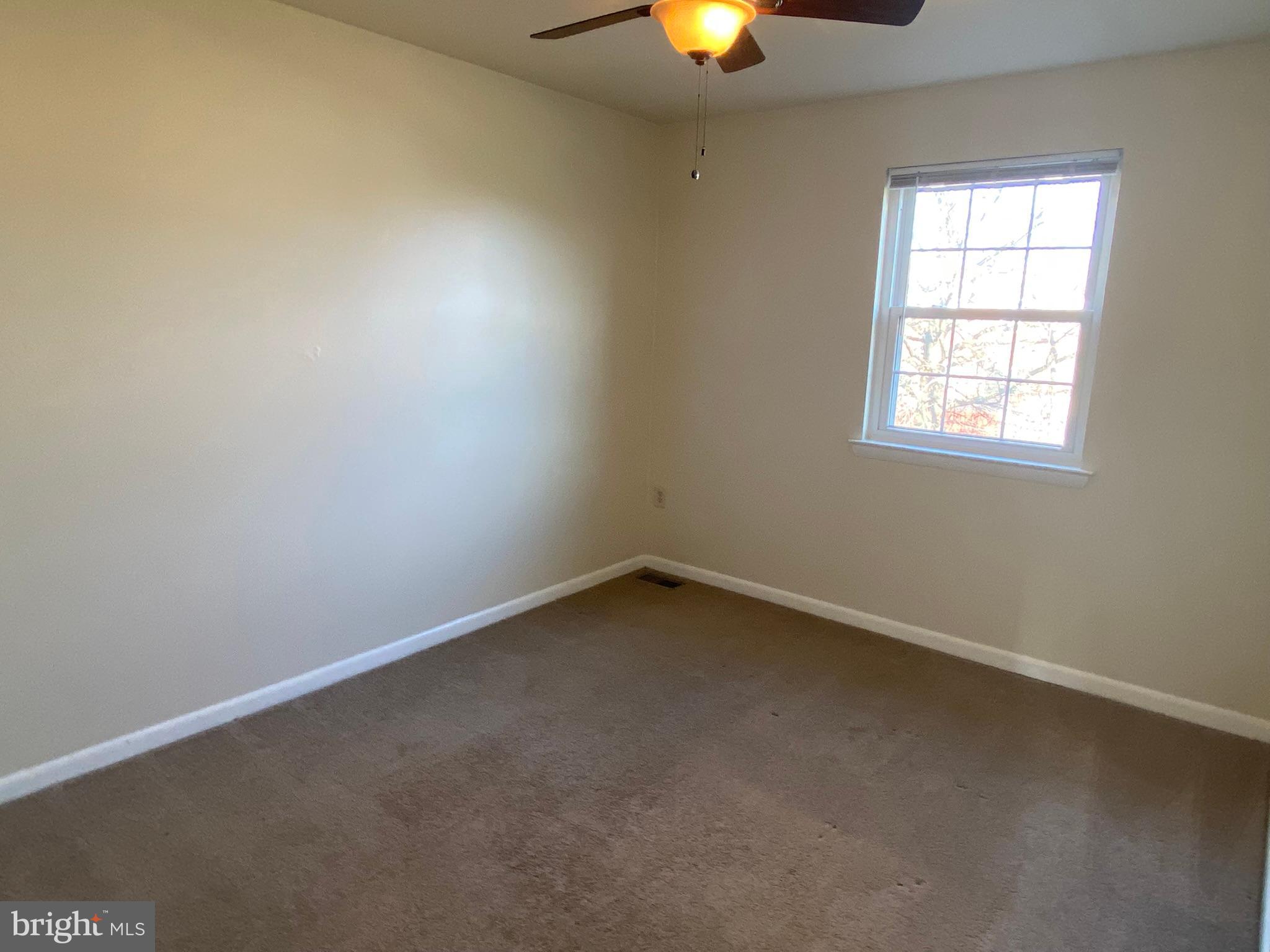7432 Pohick Road Lorton, VA 22079 - Photo 20 of 27 an empty room with a window and a fireplace