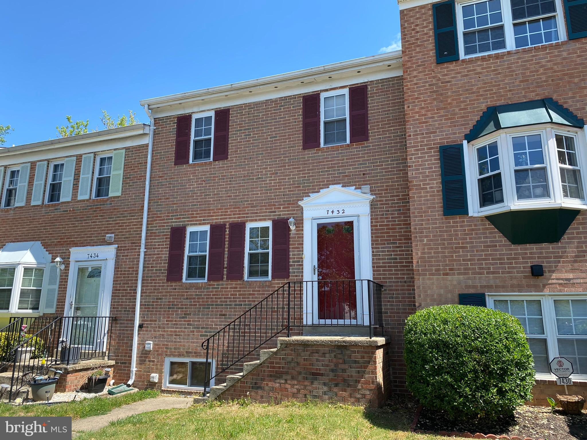 7432 Pohick Road Lorton, VA 22079 - Photo 26 of 27 a brick building with a yard in front of it