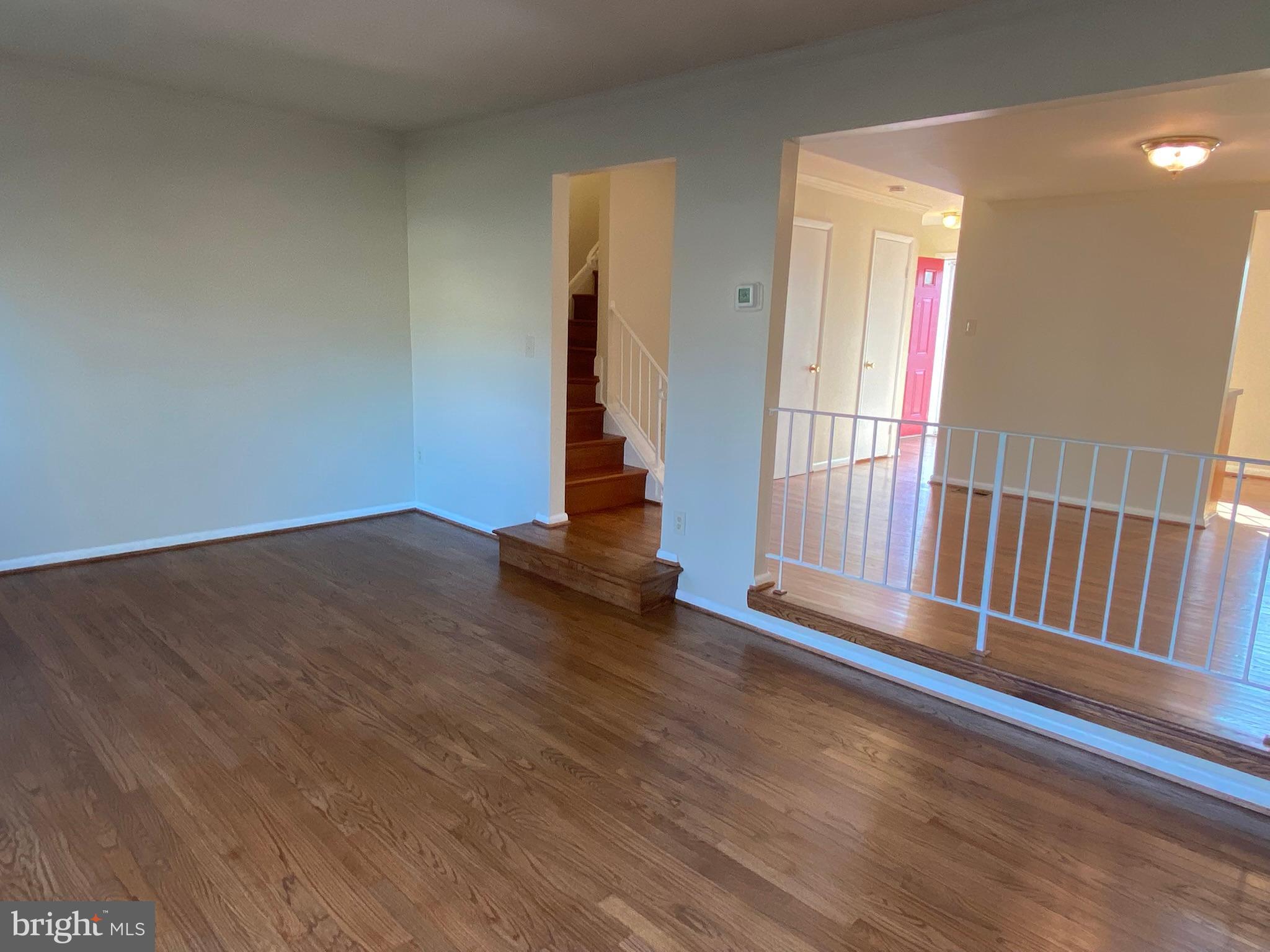 7432 Pohick Road Lorton, VA 22079 - Photo 7 of 27 an empty room with wooden floor and windows