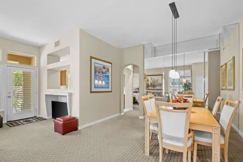 a dining room with furniture fireplace and a window