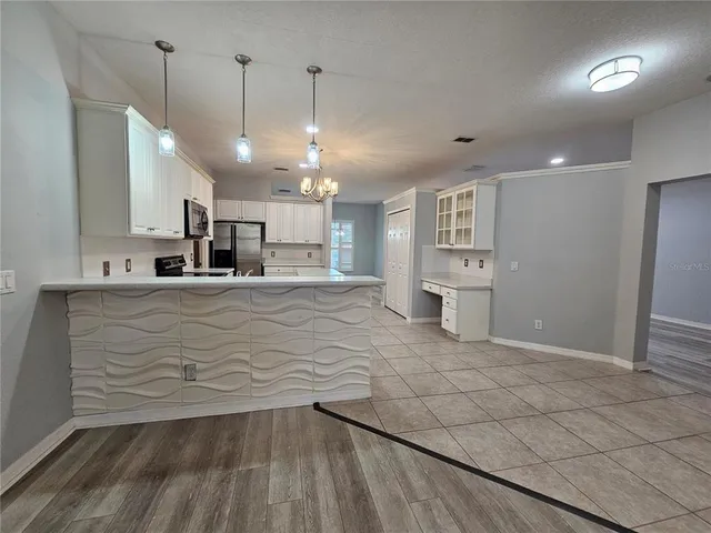 a view of a kitchen with a sink and cabinets