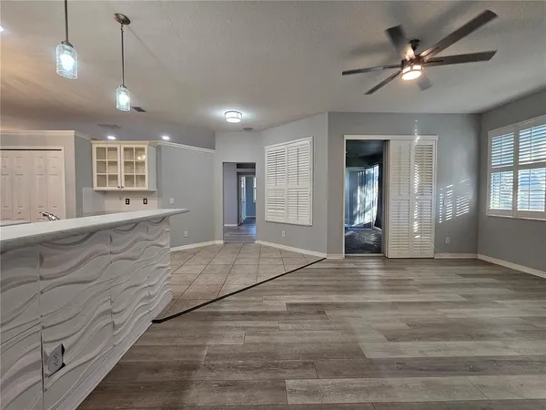 a view of an empty room with window and cabinet