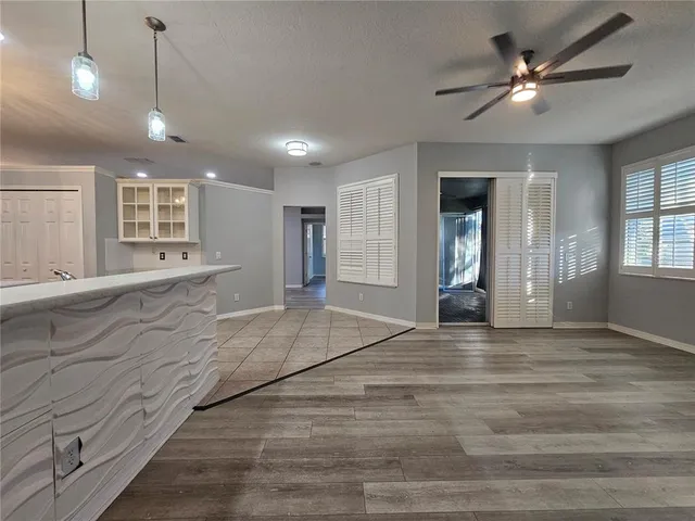 a view of an empty room with window and cabinet