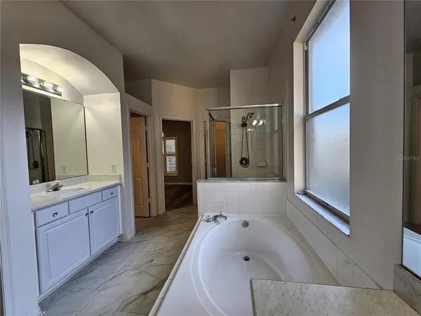a bathroom with a bathtub and a shower