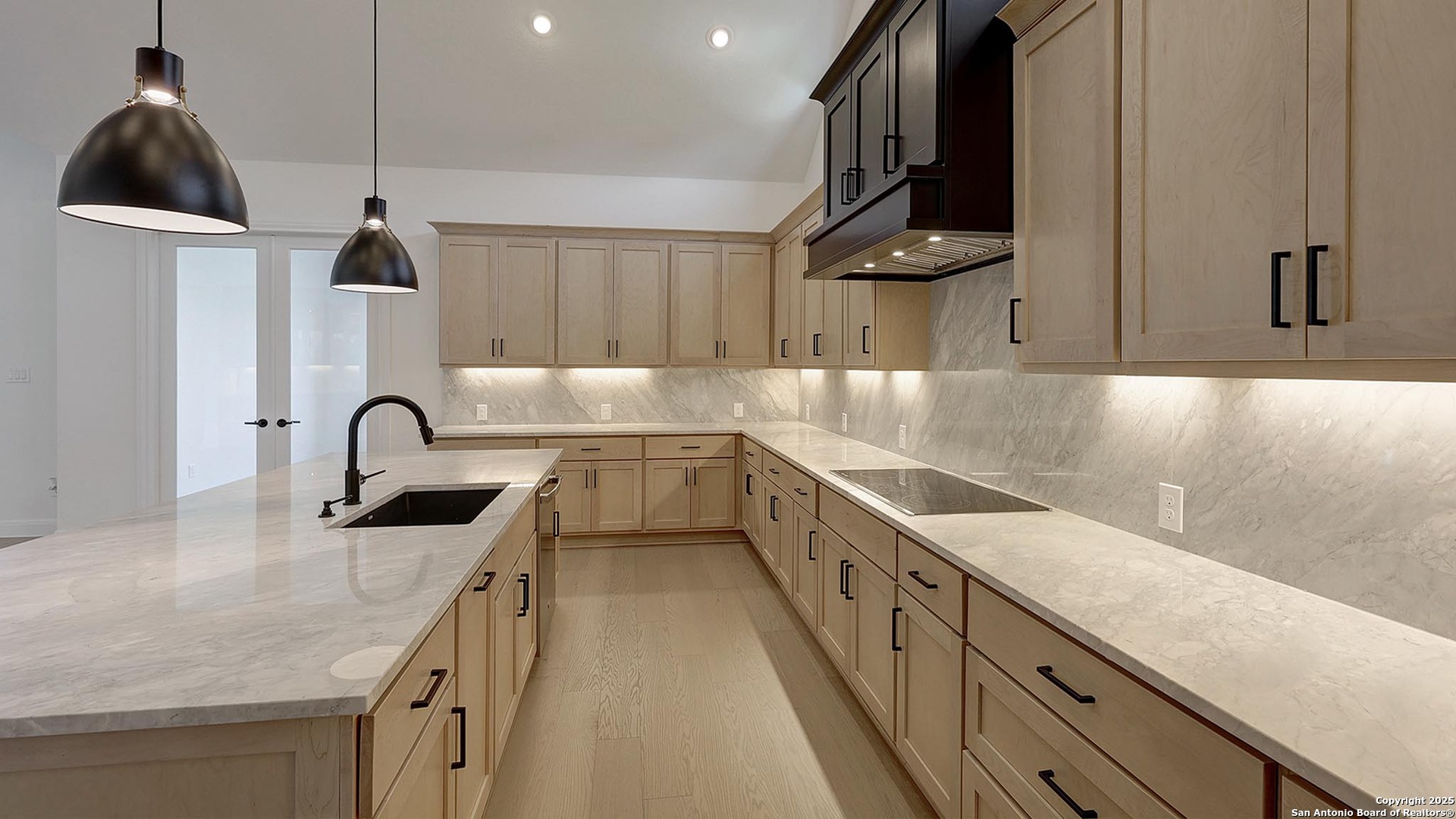 200 Violet Way Castroville, TX 78009 - Photo 11 of 32 a kitchen with kitchen island a sink stainless steel appliances and cabinets