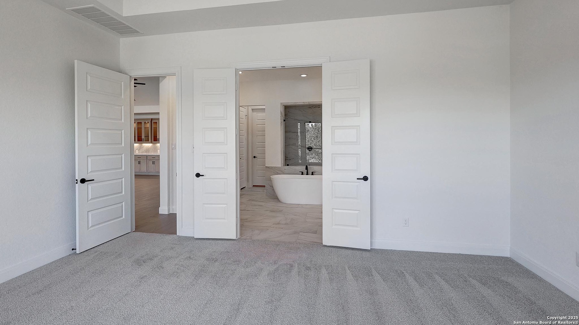 200 Violet Way Castroville, TX 78009 - Photo 13 of 32 an empty room with closet and mirror