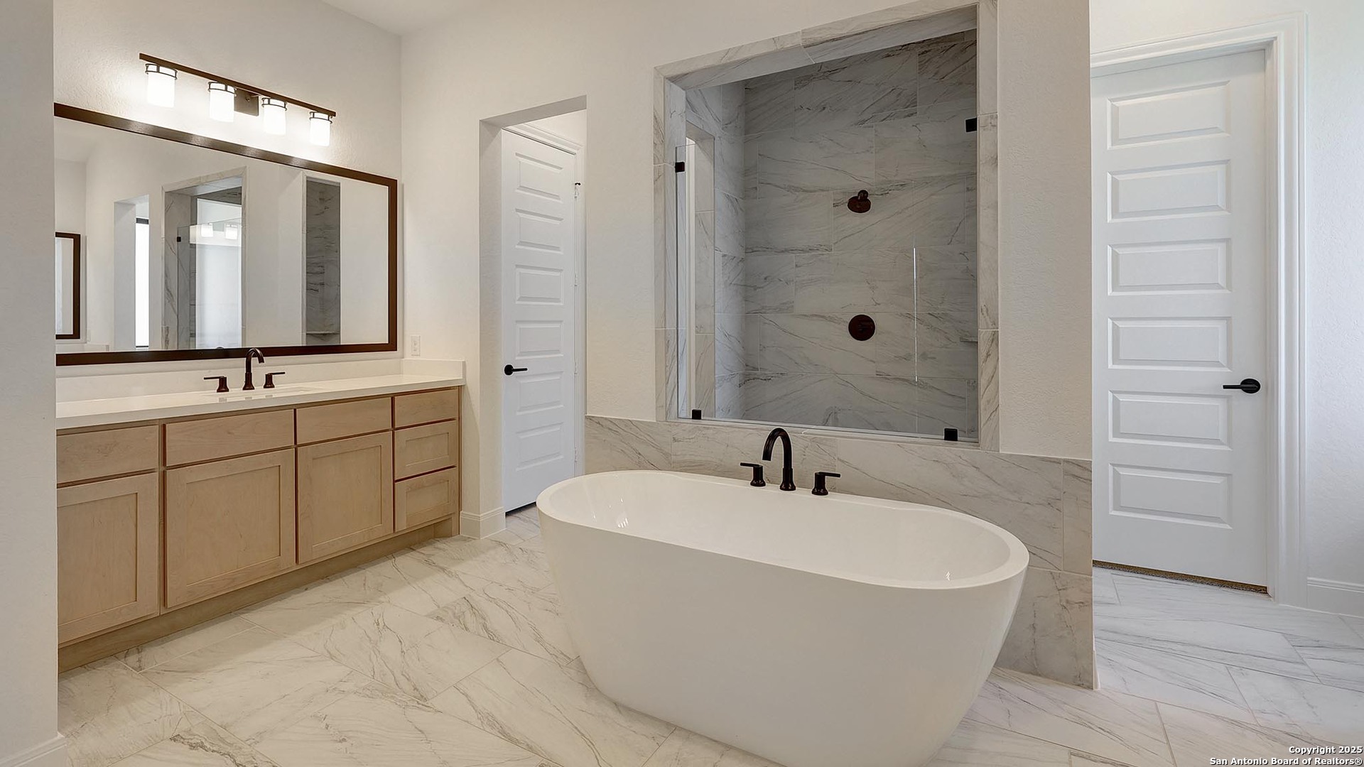 200 Violet Way Castroville, TX 78009 - Photo 14 of 32 a bathroom with a tub sink and mirror
