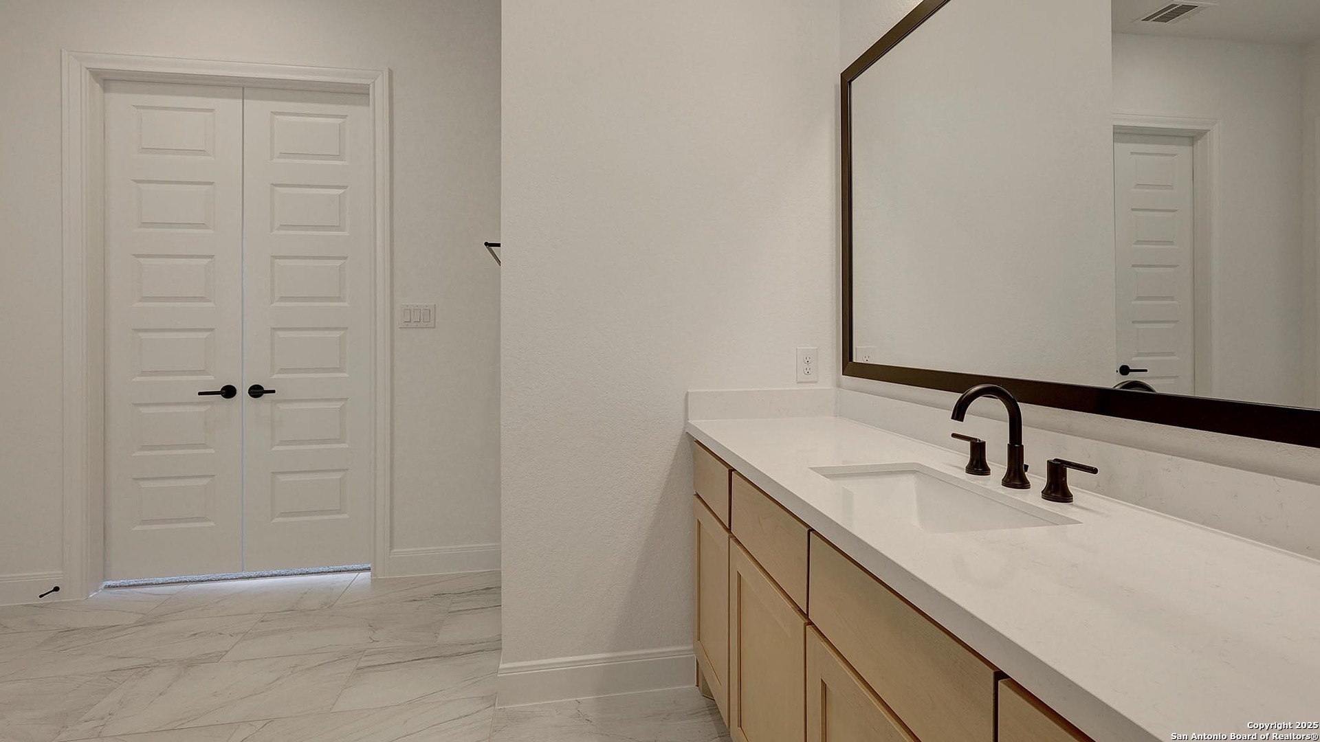200 Violet Way Castroville, TX 78009 - Photo 16 of 32 a bathroom with a sink and a mirror