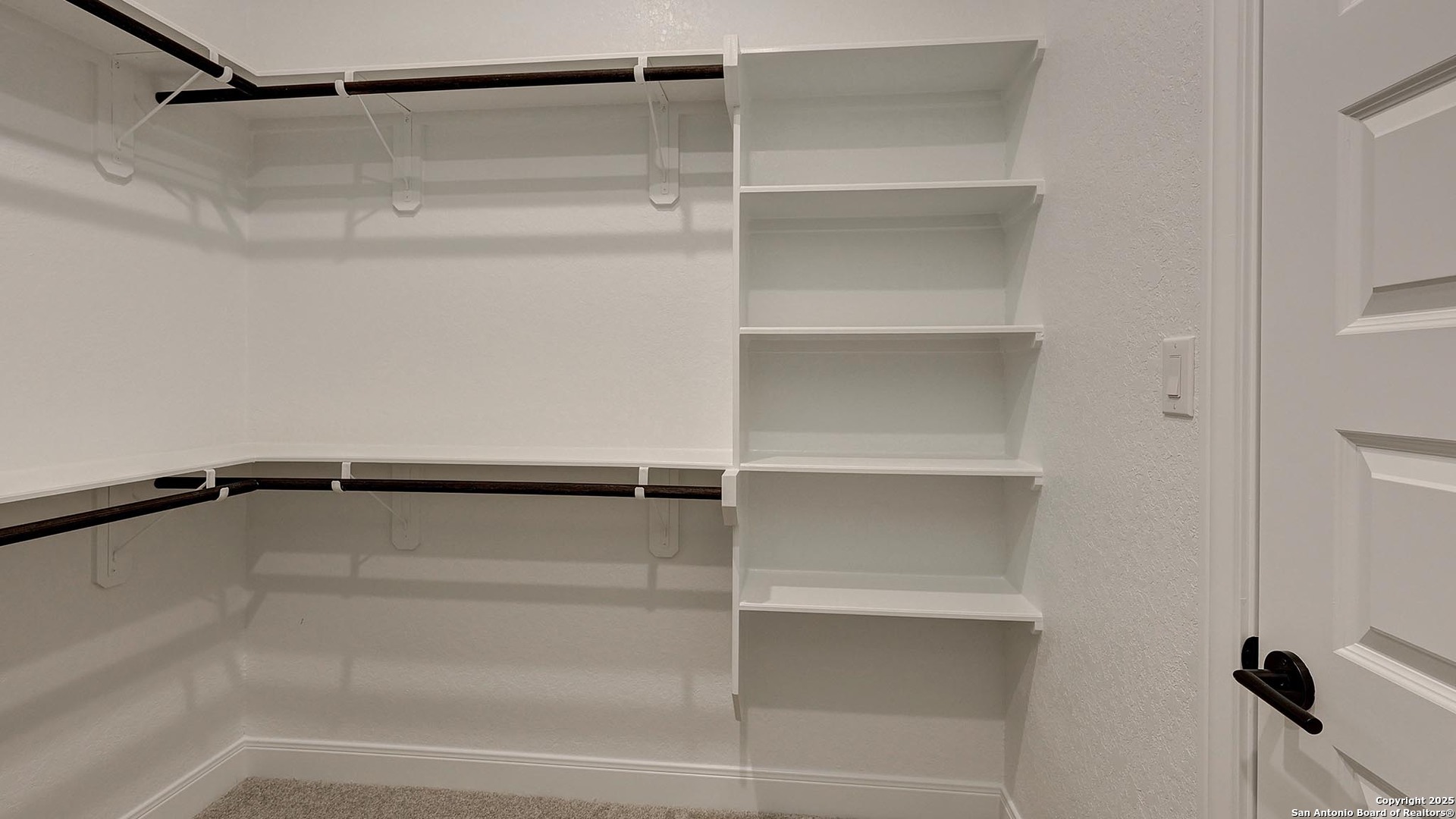 200 Violet Way Castroville, TX 78009 - Photo 20 of 32 a view of walk in closet with empty racks