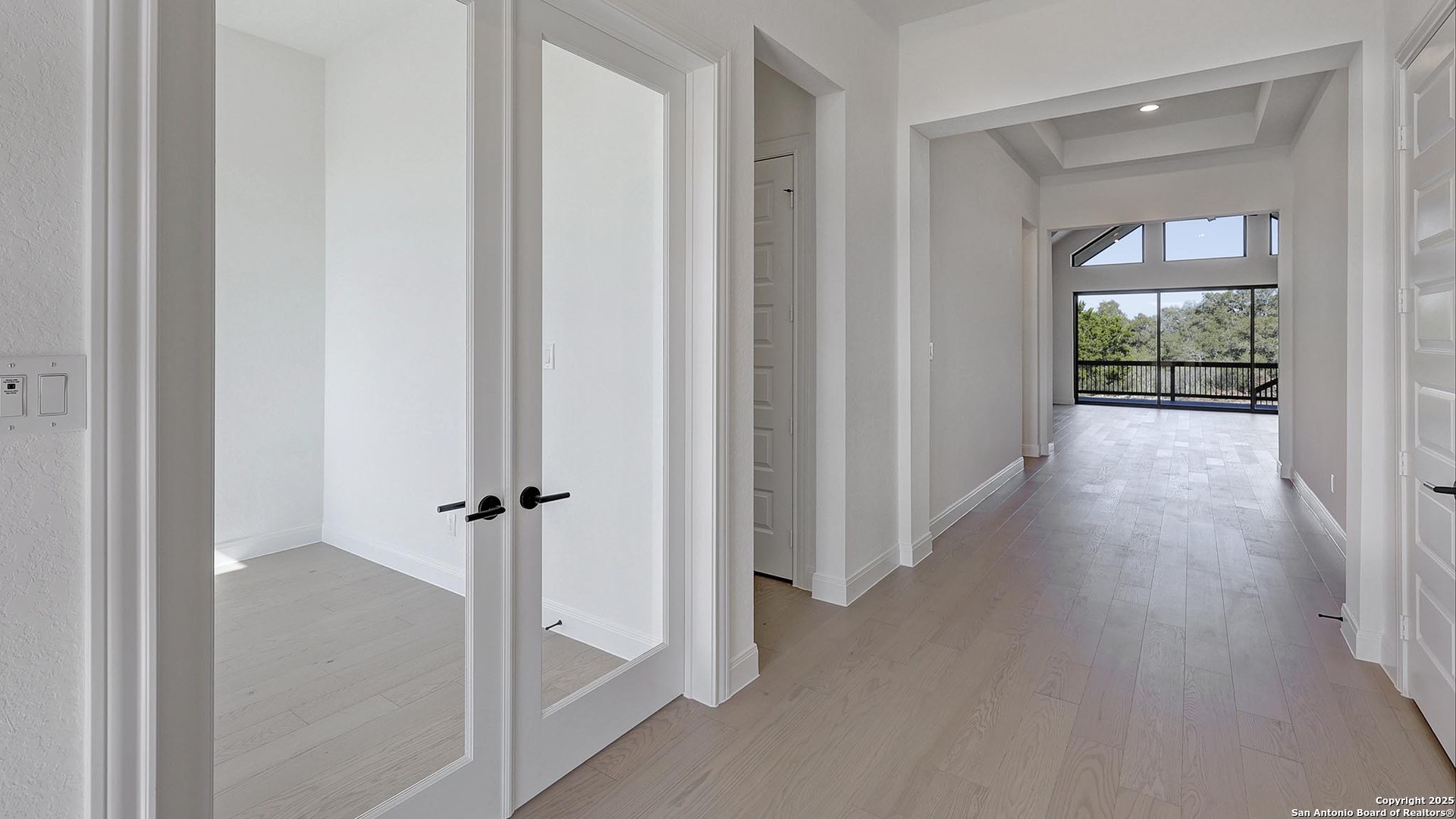 200 Violet Way Castroville, TX 78009 - Photo 7 of 32 a view of a hallway with wooden floor and front door