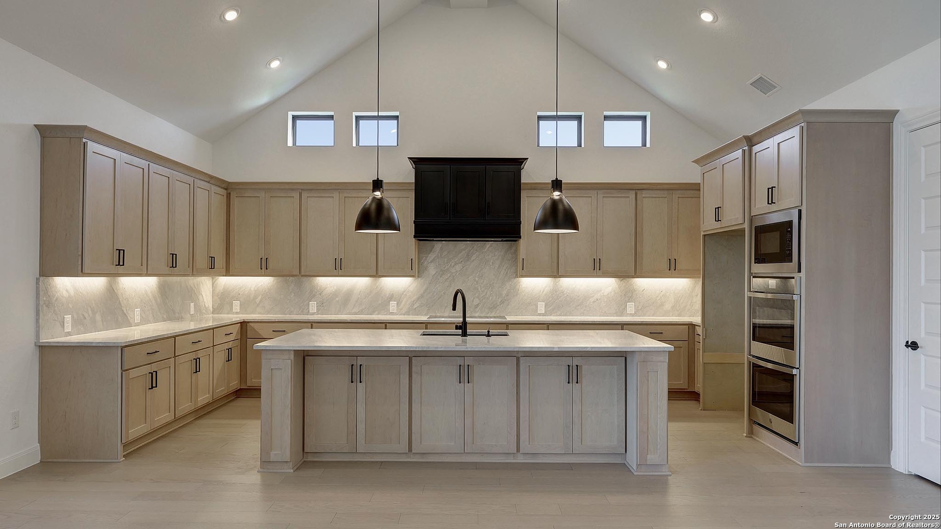 200 Violet Way Castroville, TX 78009 - Photo 8 of 32 a kitchen with stainless steel appliances granite countertop a sink and a refrigerator