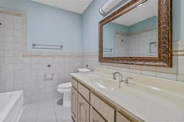 a bathroom with a sink toilet and mirror