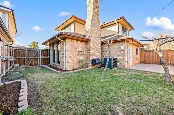 a backyard of a house with barbeque oven table and chairs