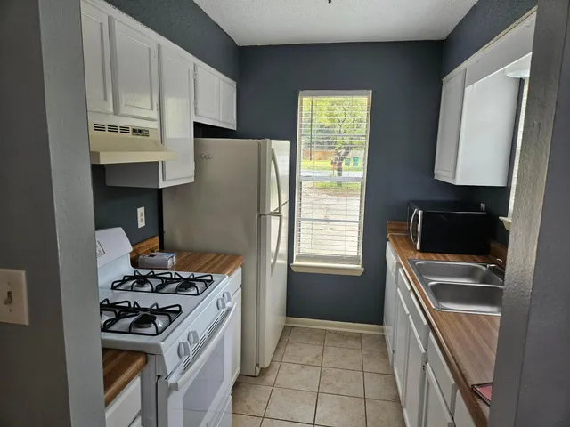 a kitchen with a stove and a microwave