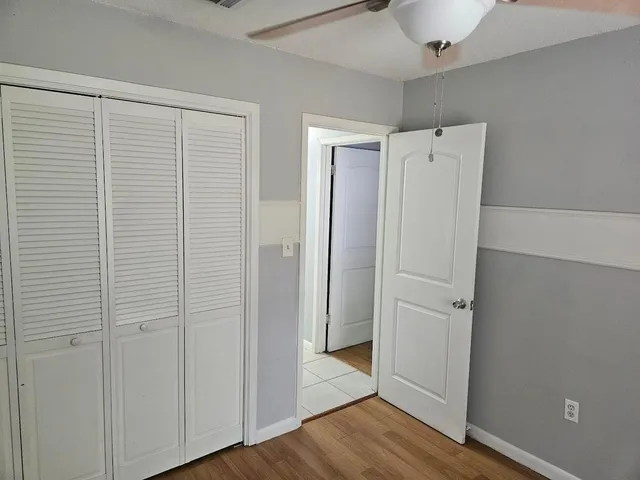 a view of closet area with wooden floor