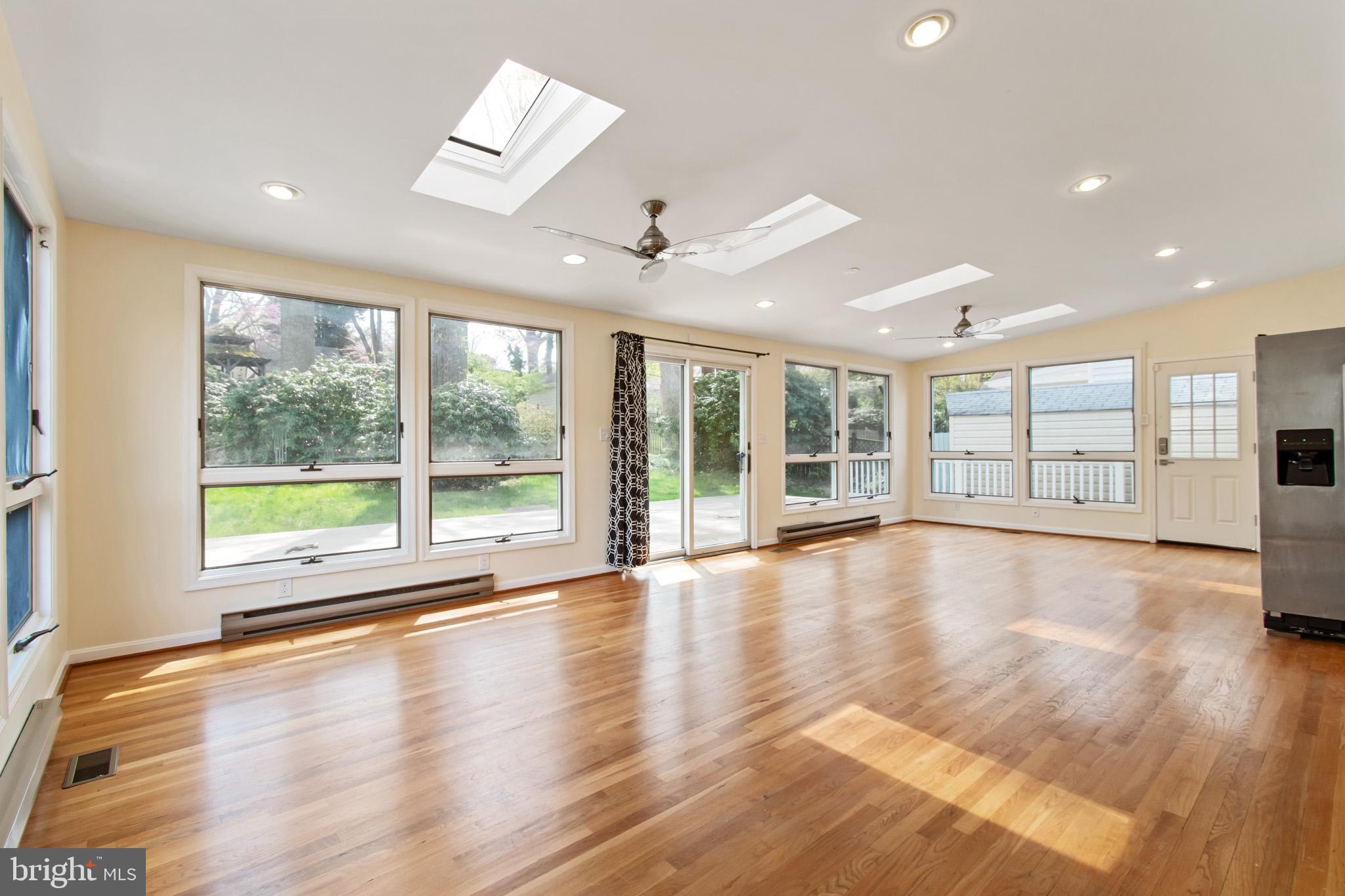 512 Carr Avenue Rockville, MD 20850 - Photo 15 of 56 a view of an empty room with wooden floor and a window