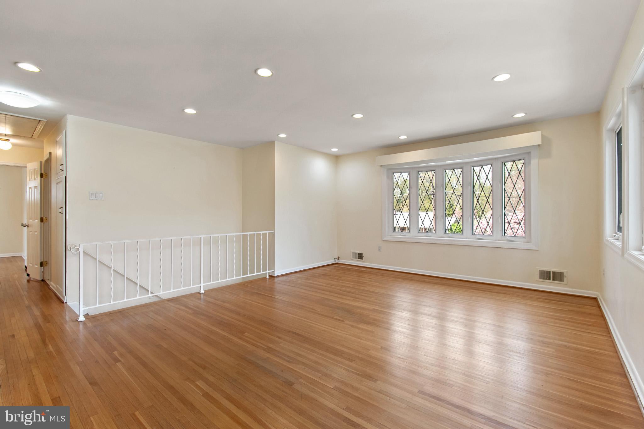 512 Carr Avenue Rockville, MD 20850 - Photo 21 of 56 an empty room with wooden floor and windows