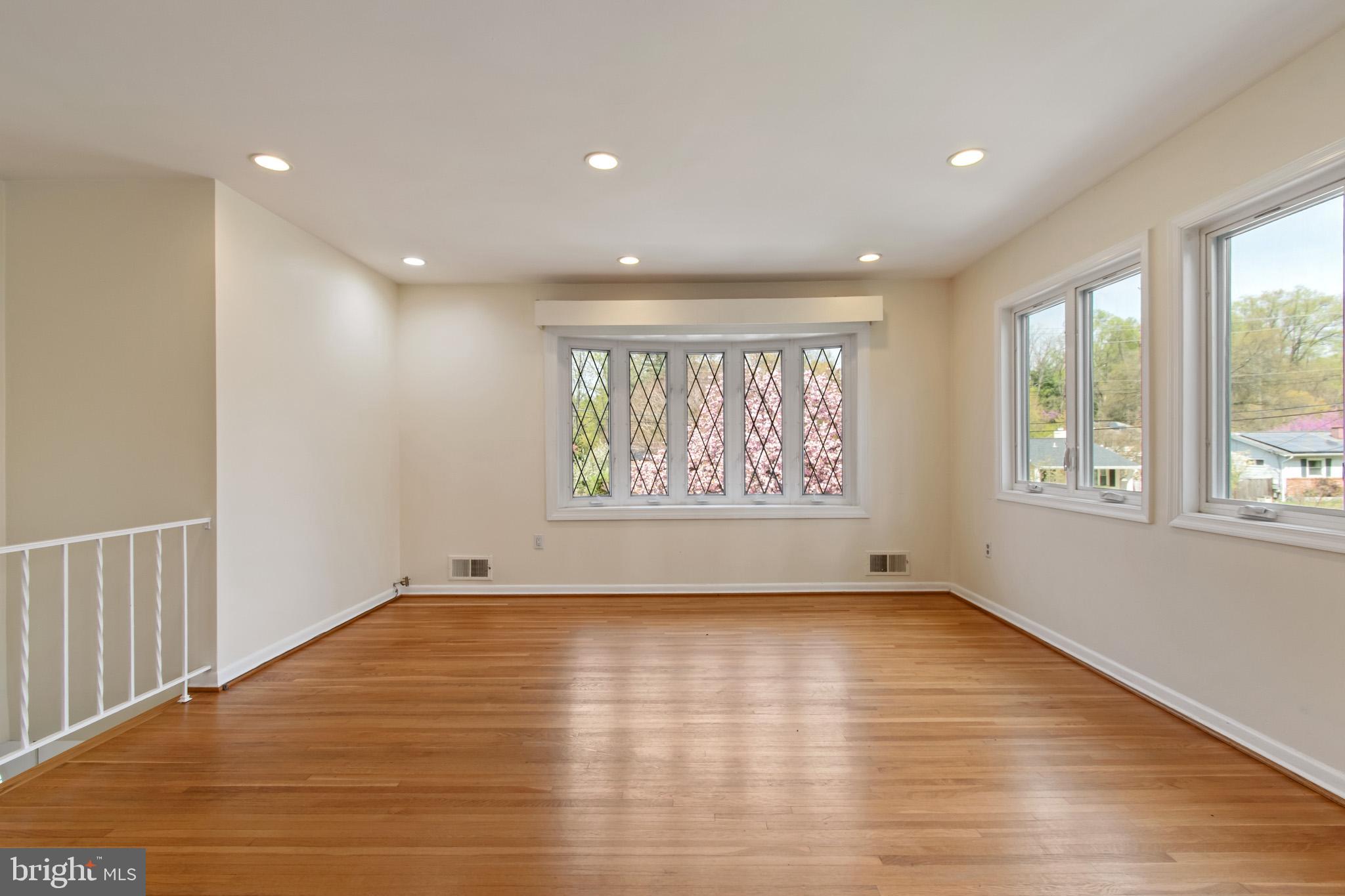 512 Carr Avenue Rockville, MD 20850 - Photo 22 of 56 a view of an empty room with wooden floor and a window
