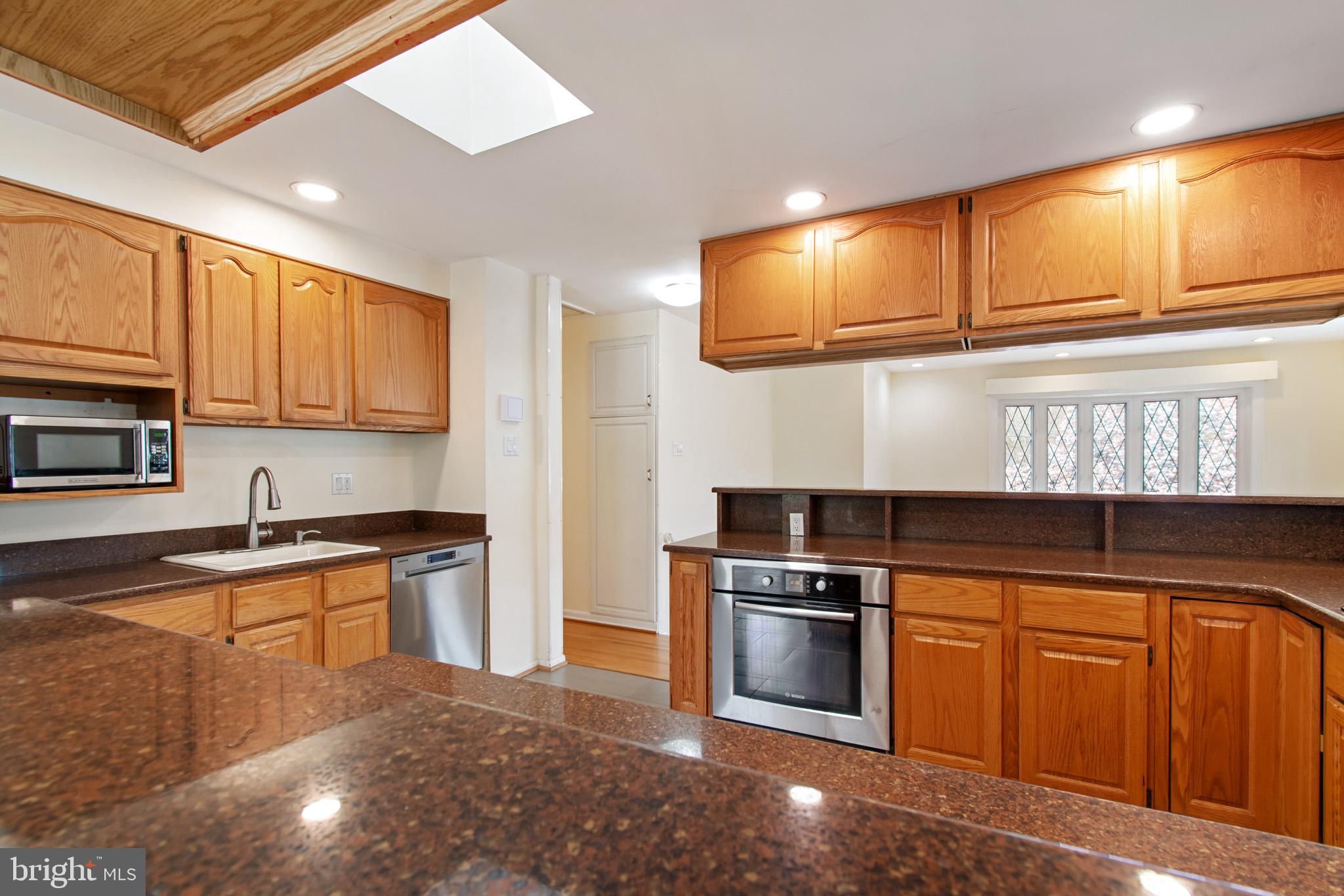 512 Carr Avenue Rockville, MD 20850 - Photo 24 of 56 a kitchen with stainless steel appliances granite countertop a stove sink and cabinets