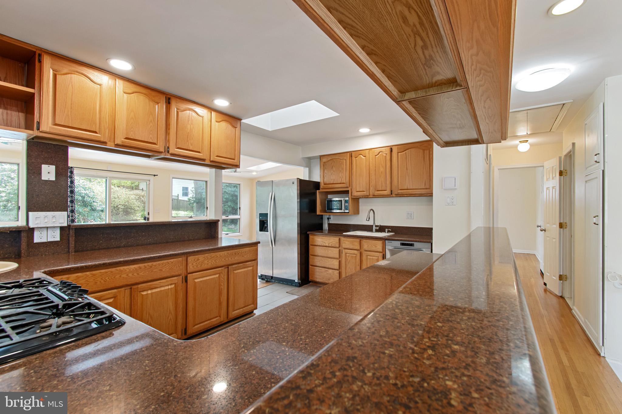 512 Carr Avenue Rockville, MD 20850 - Photo 28 of 56 a kitchen with stainless steel appliances granite countertop a refrigerator and a stove top oven