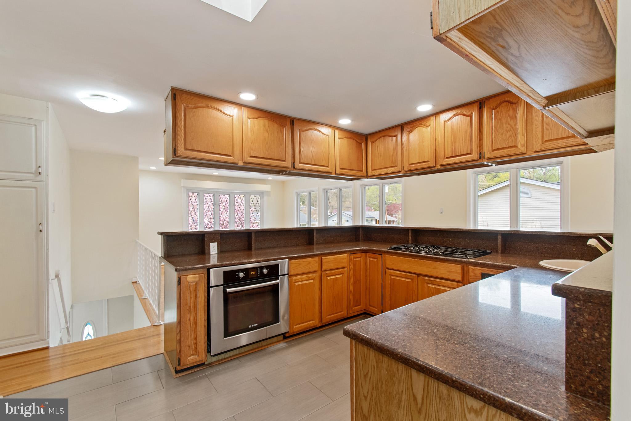 512 Carr Avenue Rockville, MD 20850 - Photo 29 of 56 a kitchen with stainless steel appliances granite countertop a sink and a stove
