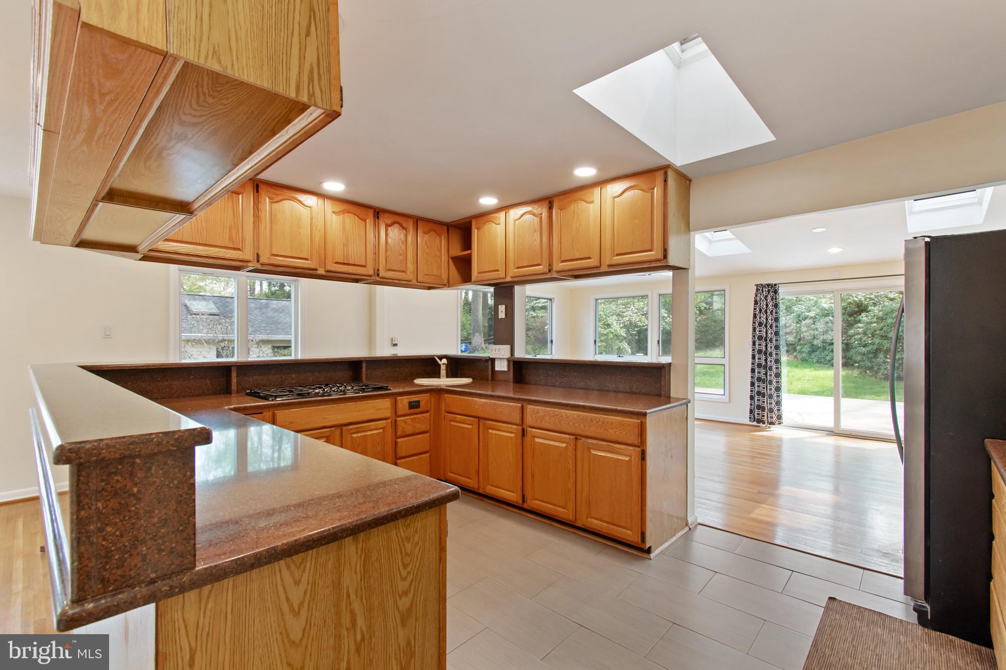 512 Carr Avenue Rockville, MD 20850 - Photo 30 of 56 a kitchen with stainless steel appliances granite countertop sink stove and refrigerator