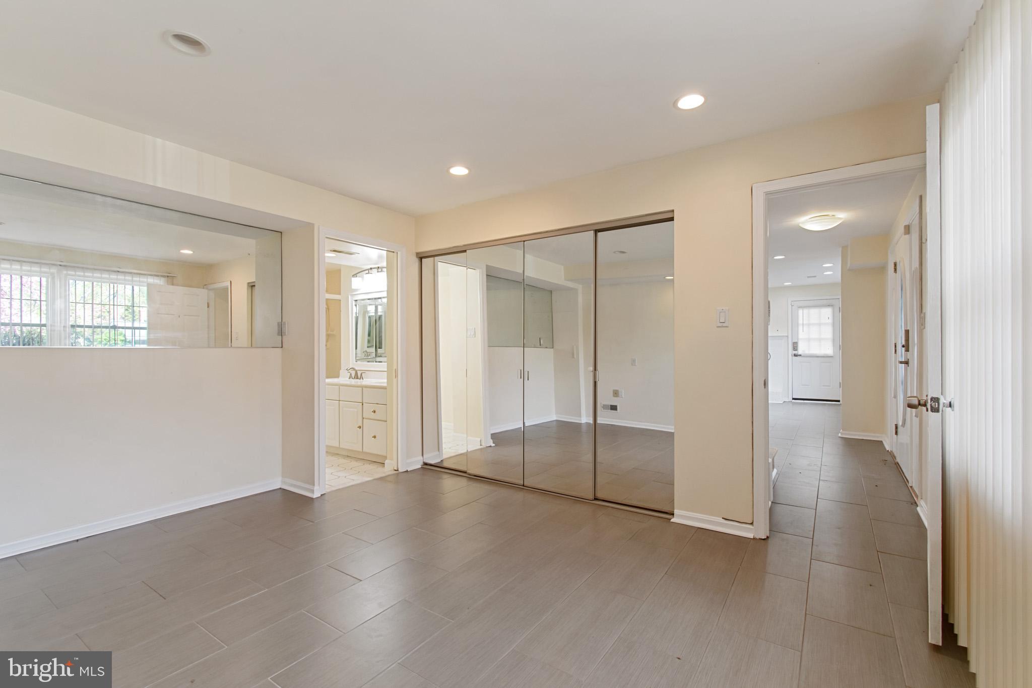 512 Carr Avenue Rockville, MD 20850 - Photo 33 of 56 a view of an empty room with wooden floor and a bathroom