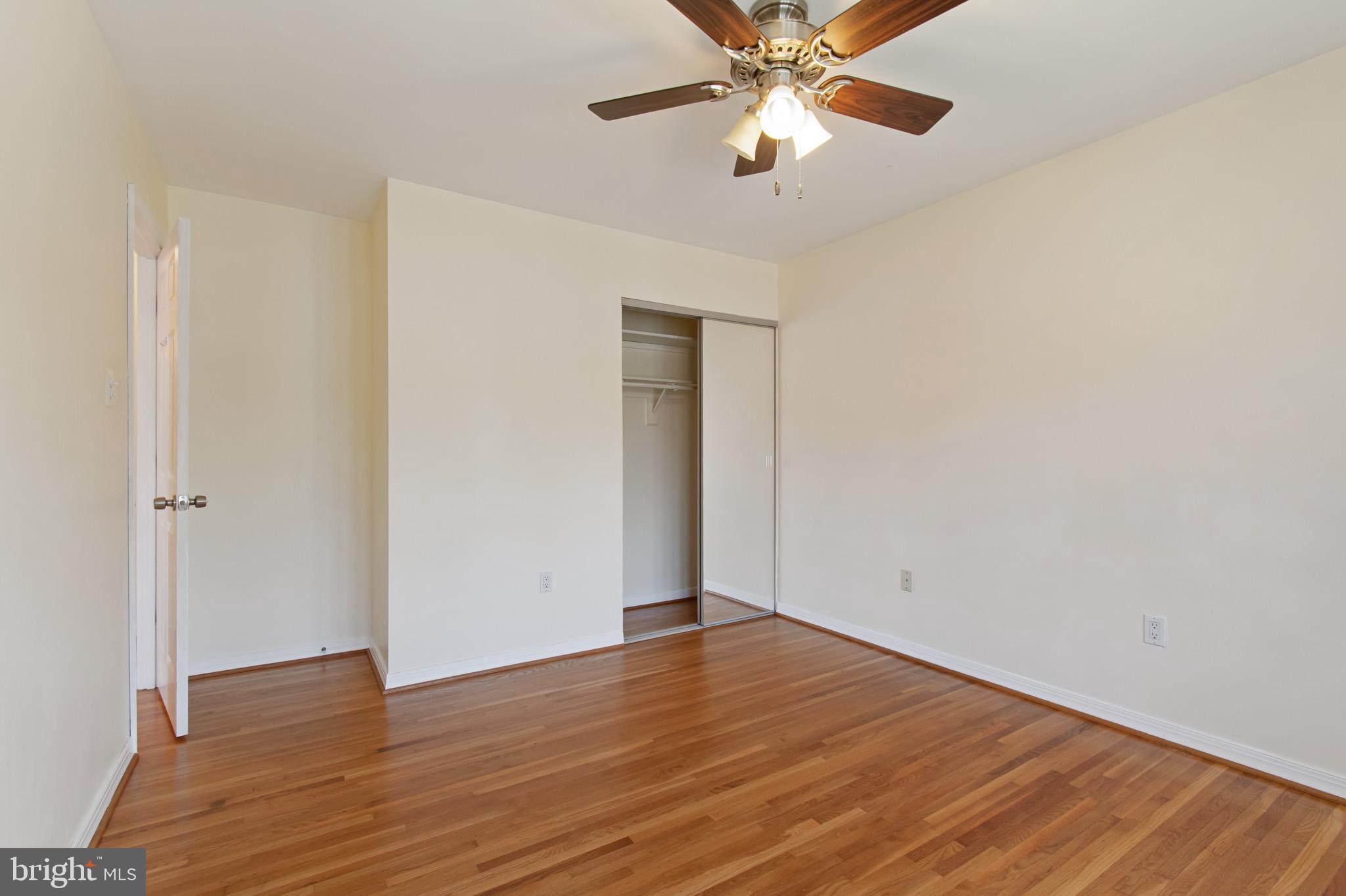 512 Carr Avenue Rockville, MD 20850 - Photo 35 of 56 an empty room with wooden floor closet and ceiling fan