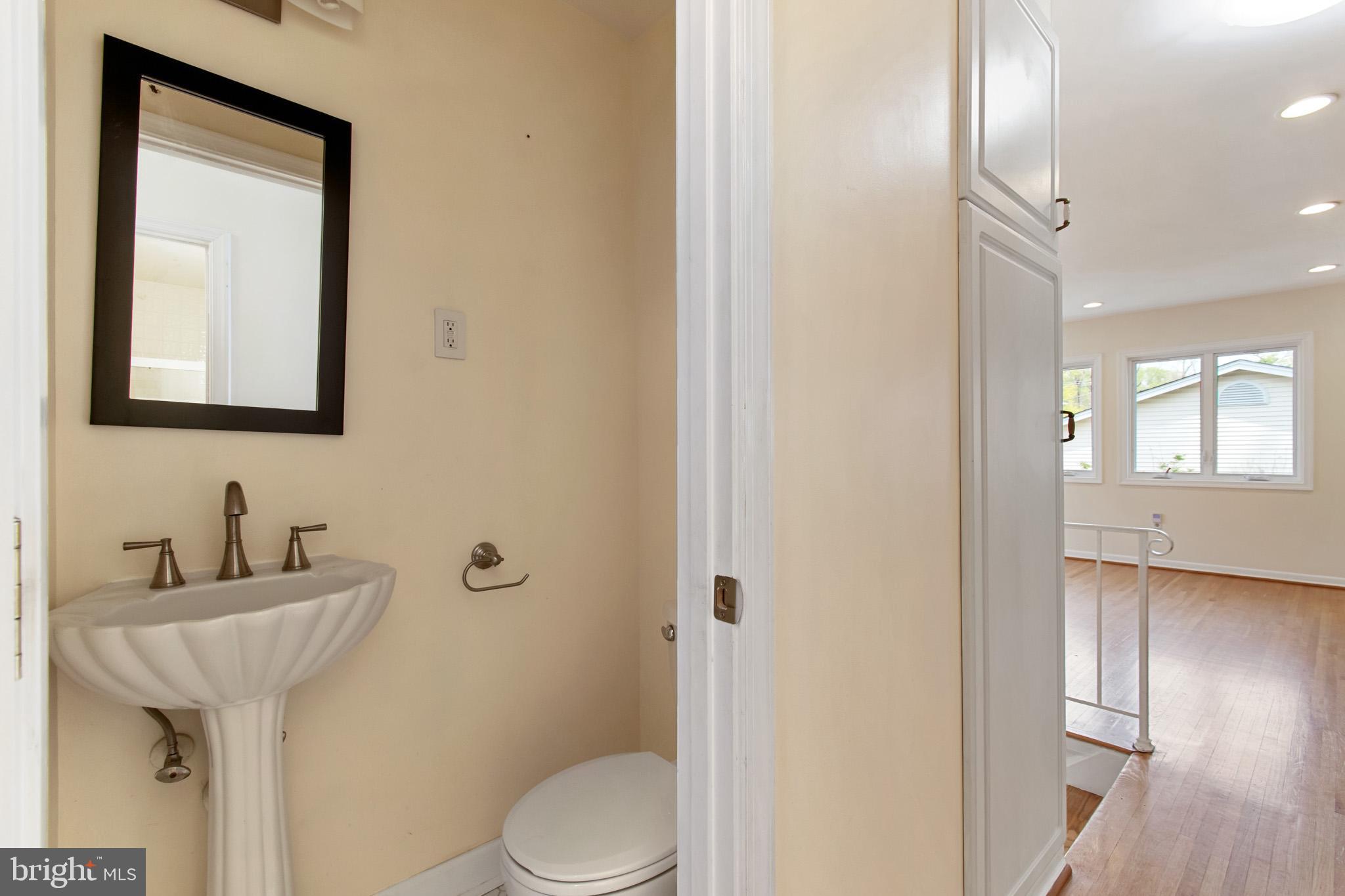 512 Carr Avenue Rockville, MD 20850 - Photo 41 of 56 a bathroom with a toilet a sink and mirror