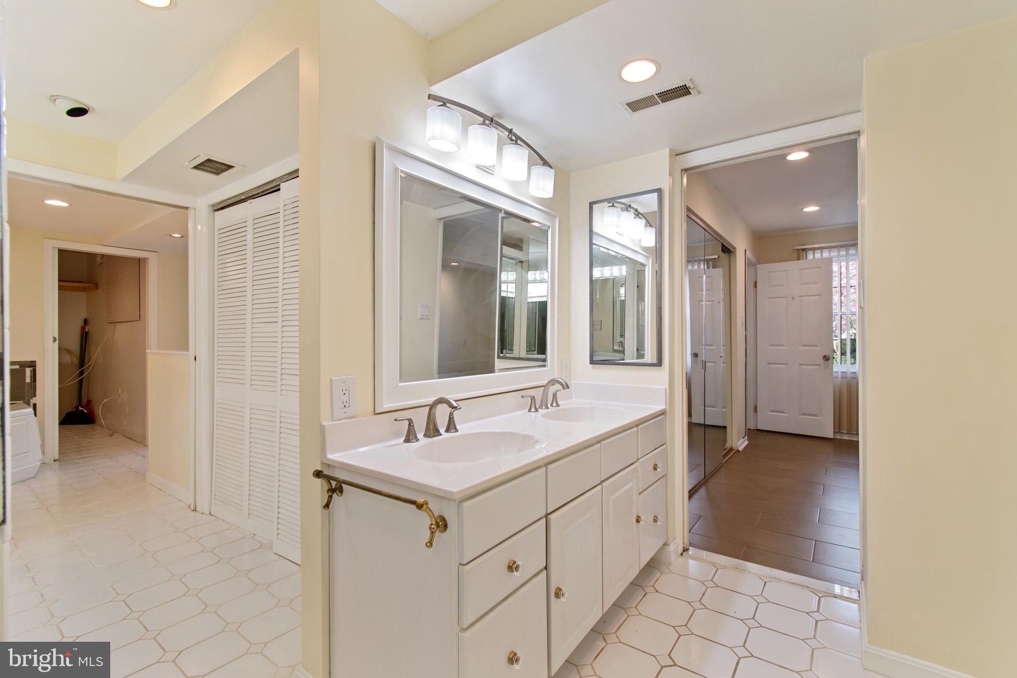 512 Carr Avenue Rockville, MD 20850 - Photo 44 of 56 a spacious bathroom with a double vanity sink mirror and shower