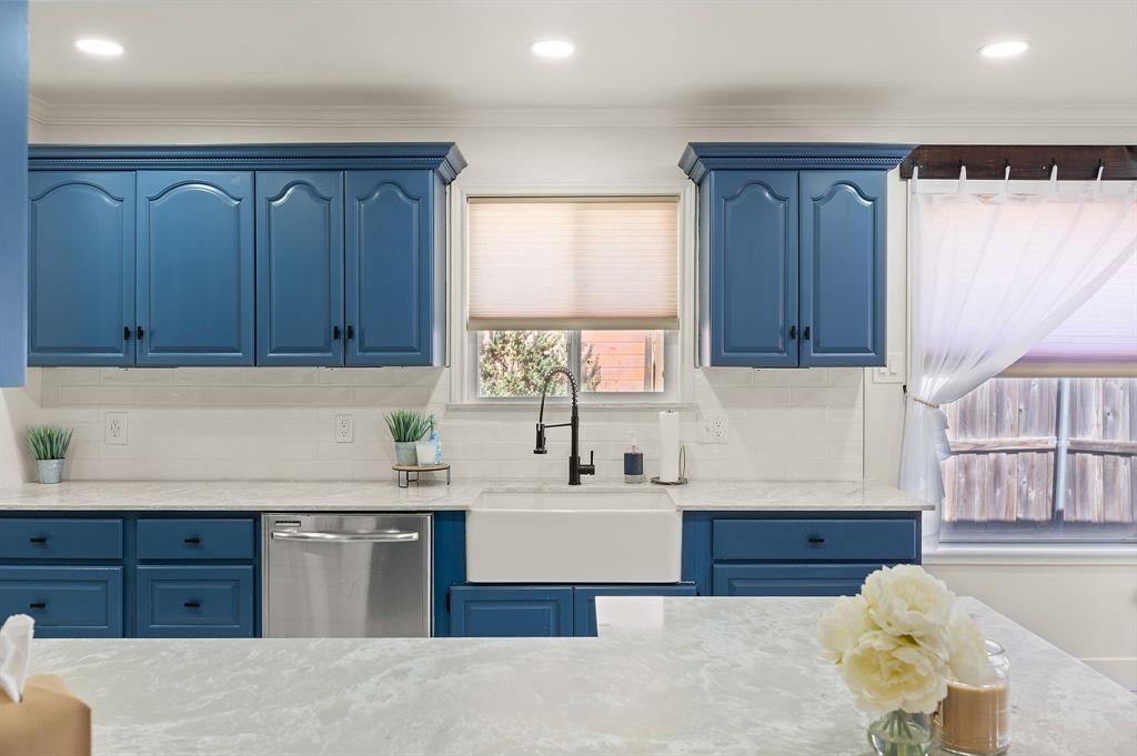 305 Maverick Trail Oak Point, TX 75068 - Photo 17 of 40 a kitchen with granite countertop wooden cabinets a sink and dishwasher