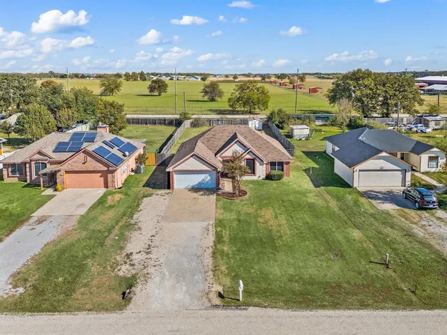 an aerial view of a house with big yard
