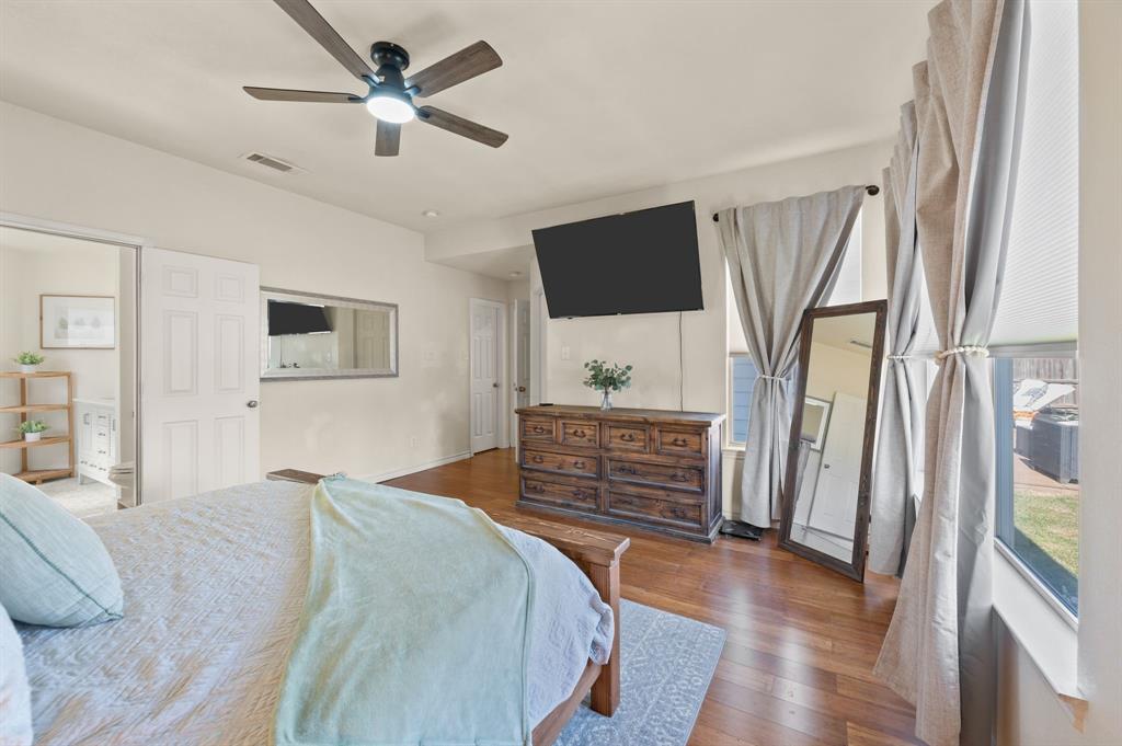 305 Maverick Trail Oak Point, TX 75068 - Photo 22 of 40 a bedroom with a bed and a flat screen tv