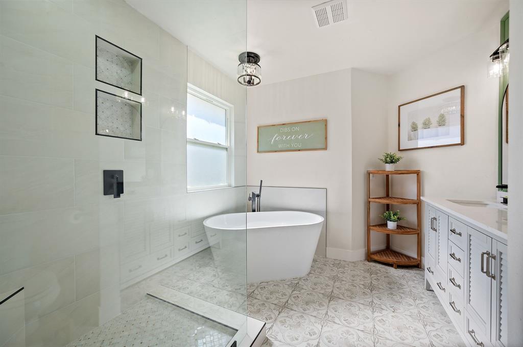 305 Maverick Trail Oak Point, TX 75068 - Photo 23 of 40 a spacious bathroom with a bathtub and a sink