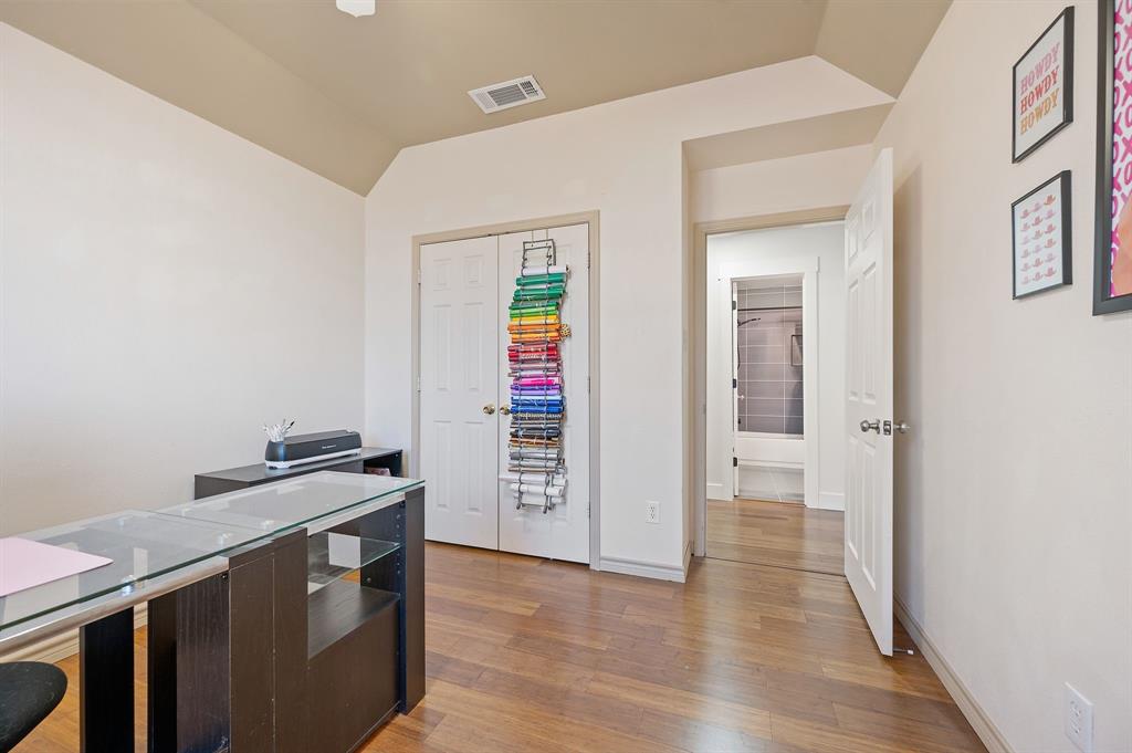 305 Maverick Trail Oak Point, TX 75068 - Photo 27 of 40 a view of a kitchen with fridge and wooden floor