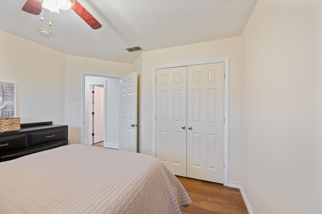 305 Maverick Trail Oak Point, TX 75068 - Photo 30 of 40 a bedroom with a bed and cabinets