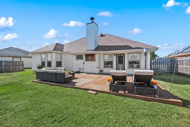 a house view with a sitting space and garden