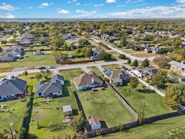 an aerial view of residential houses with outdoor space