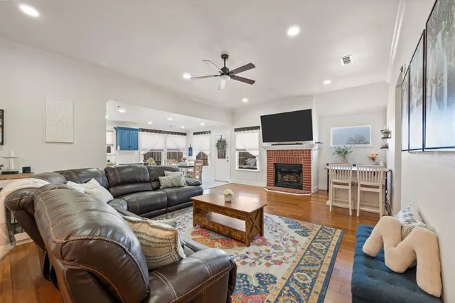 a living room with furniture a fireplace and a flat screen tv