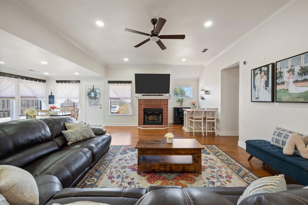 305 Maverick Trail Oak Point, TX 75068 - Photo 8 of 40 a living room with furniture a fireplace