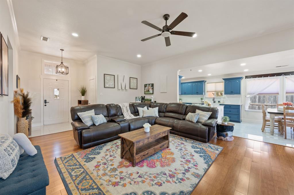 305 Maverick Trail Oak Point, TX 75068 - Photo 9 of 40 a living room with furniture kitchen view and a wooden floor
