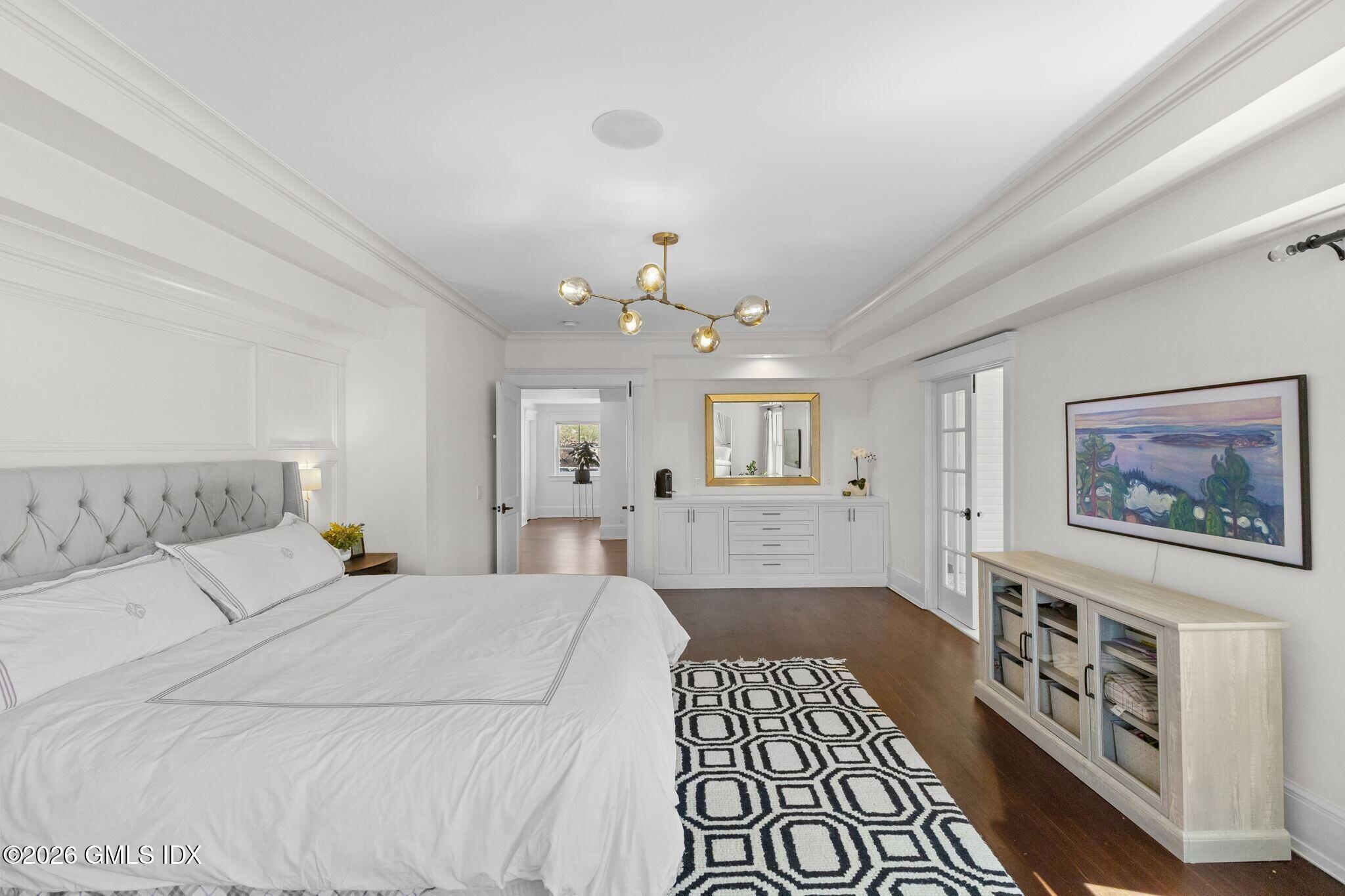 311 Riversville Road Greenwich, CT 06831 - Photo 20 of 32 a bedroom with a large bed a chandelier and a window